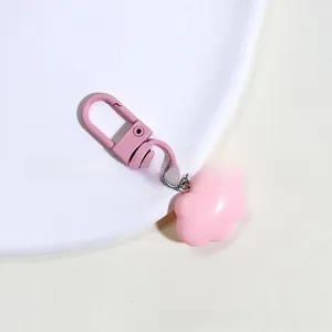 Close-up of pink macaron cloud pendant with matching alloy spring clasp on white plate