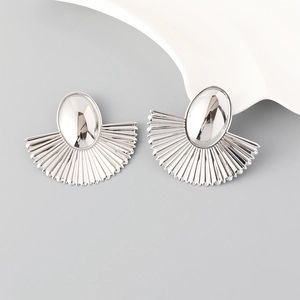 Macro view of silver geometric fan-shaped earrings with polished metallic texture