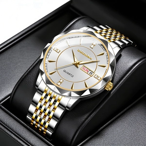 Men's business watch with silver dial, gold accents, and dual calendar on black leather pillow