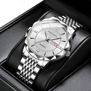 Detail of diamond-cut bezel and rhinestone dial on stainless steel calendar watch