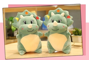 Close-up of green triceratops plush with colorful fruit embroidery and soft velvet texture