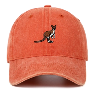 Close-up of kangaroo embroidery on a vintage coral orange washed cotton baseball cap