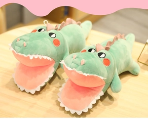 Close-up of soft crocodile plush slippers in mint green and pink with embroidery