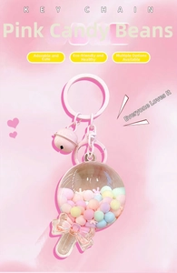 Close-up of pink lollipop keychain with internal macaron beads and bell detail