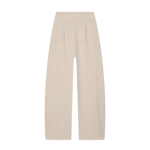 Detail of high waist pleated trousers in beige showing the wide leg balloon fit design