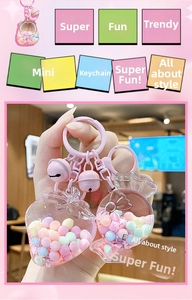 Close-up of pink strawberry and candy acrylic keychains with colorful beads inside