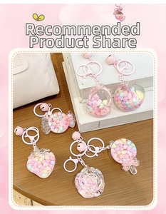 Macro detail of assorted pink candy-themed keychains with colorful inner beads on wood