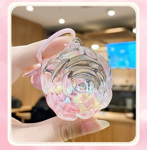 Close-up of heart-filled acrylic rose keychain with pink ring clip held in hand