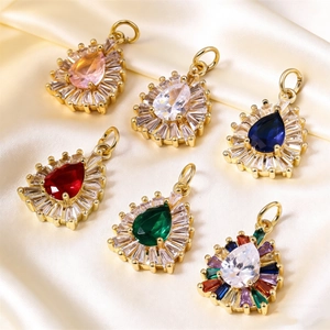 Detailed view of teardrop crystal pendants with gold metal base and zircon halo