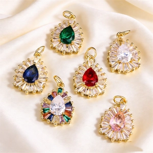 Teardrop crystal pendants in various colors with sunburst halo and gold-plated settings