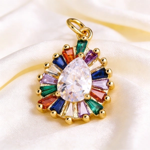 Detailed macro view of a teardrop crystal pendant with colorful gemstones on silk fabric