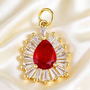 Macro detail of pear-shaped red gemstone pendant with white zircon halo on silk