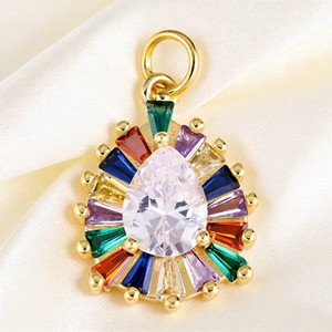 Macro shot of colorful pear-cut crystal pendant on elegant cream silk background
