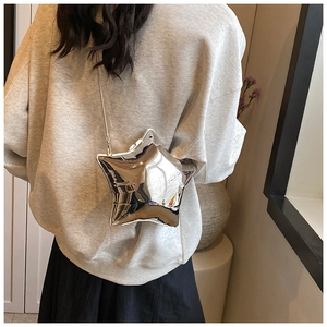 Close-up of a shiny silver star-shaped acrylic mini bag with a metallic chain strap