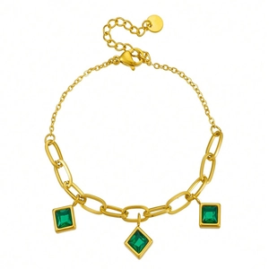 Gold paperclip bracelet with three green square cubic zirconia and adjustable chain