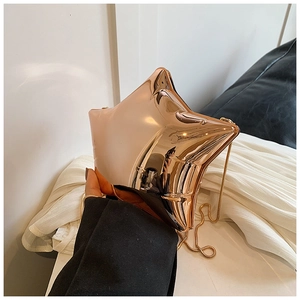 Detailed view of glossy star-shaped acrylic evening clutch with gold chain strap