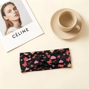 Black twist headband for girls with colorful bow prints on minimalist background