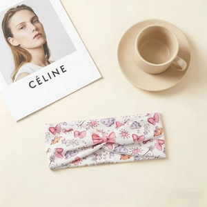 Detailed view of kids cartoon graffiti headband with cross knot design and soft cotton texture