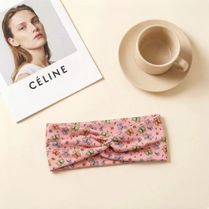 Pink elastic headband with colorful butterfly prints and a twisted knot design for kids
