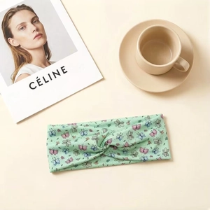 Green twist headband for girls with colorful butterfly print in soft elastic fabric