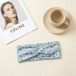 Detail of light blue knot headband with butterfly print on soft elastic fabric