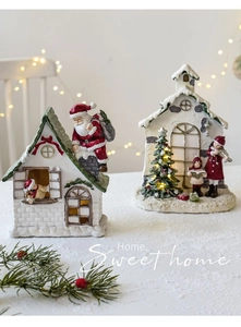 Detailed view of resin miniature Christmas house and church figurines with snow texture