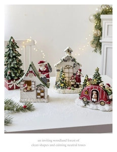 Detailed Christmas village scene featuring resin snow houses and a festive red truck