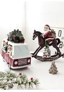 Miniature resin Christmas bus and rocking horse figurines with festive holiday decorations