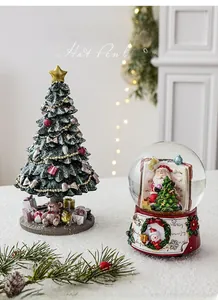 Mini resin Christmas tree and Santa snow globe ornaments for festive holiday table decor