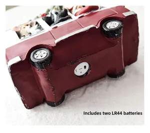Detail of red car decoration base showing battery compartment for two LR44 batteries