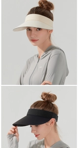 Detail view of wide brim sun visors in black and beige on model with sun protective shirt