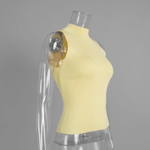 Close-up of yellow knit tank top featuring ribbed texture and elegant mock neck design