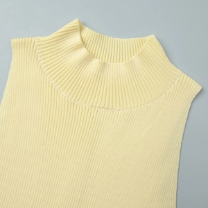 Detailed close-up of light yellow ribbed mock neck knit top with high-quality texture
