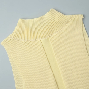 Close-up of the mock neck and vertical ribbed knit texture on a light yellow vest