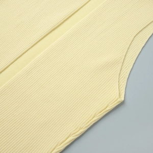 Close-up of pale yellow ribbed knit vest showing soft fabric texture and seamless edges
