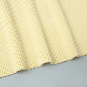 Detailed close-up of light yellow vertical ribbed knit texture with neat edge stitching