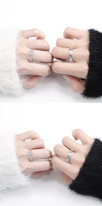 Detail of silver couple rings showing the blue enamel star and moon design on hand