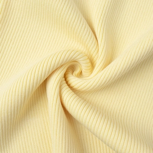 Close-up of pale yellow knitted fabric with fine ribbed texture and soft finish