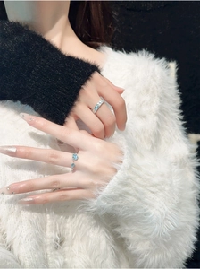 Close-up of S925 sterling silver couple rings with blue star and diamond accents