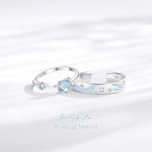 Luminous sterling silver star and meteor couple rings with blue glitter accents