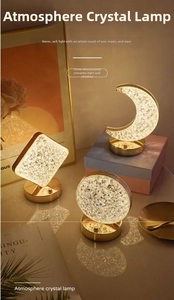 Detail of warm glow crystal lamps with geometric shapes and gold metal base