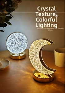 Detail of crystal star and moon lamps with gold bases on a cozy, modern side table