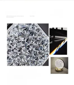 Detailed view of faceted crystal table lamp with gold base and three color temperatures