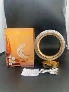 Detail of crystal night light with gold base, USB cable, and feature packaging