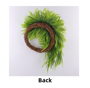 Detailed back view of artificial fern wreath with natural rattan base and leaf attachments
