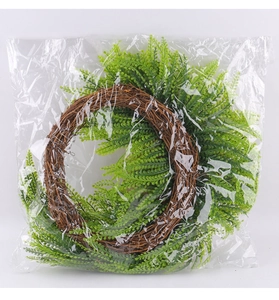 Detailed view of artificial green leaves and natural rattan wreath base texture