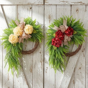 Set of two farmhouse hydrangea wreaths with burlap bows on white wooden doors