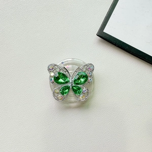 Dettaglio del supporto telefono a farfalla con gemme verde smeraldo e strass colorati