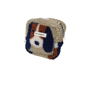 Cute puppy-shaped plush toiletry bag with zipper and May Rabbit label on white background