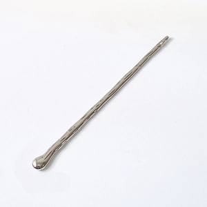 Macro detail of silver fluid metal hair stick with high-gloss mirror polished texture